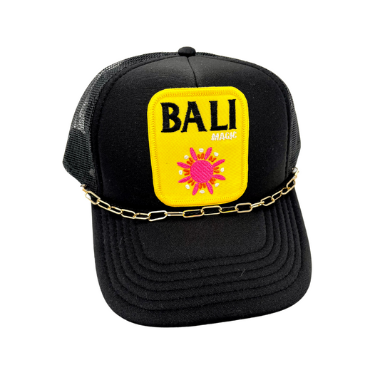 embroidered yellow Bali patch with sun on black trucker hat